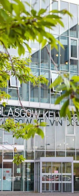 View of Glasgow Kelvin College Springburn Campus entrance seen through leafy trees, showcasing the building’s modern exterior. View of Glasgow Kelvin College Springburn Campus entrance seen through leafy trees, showcasing the building’s modern exterior.